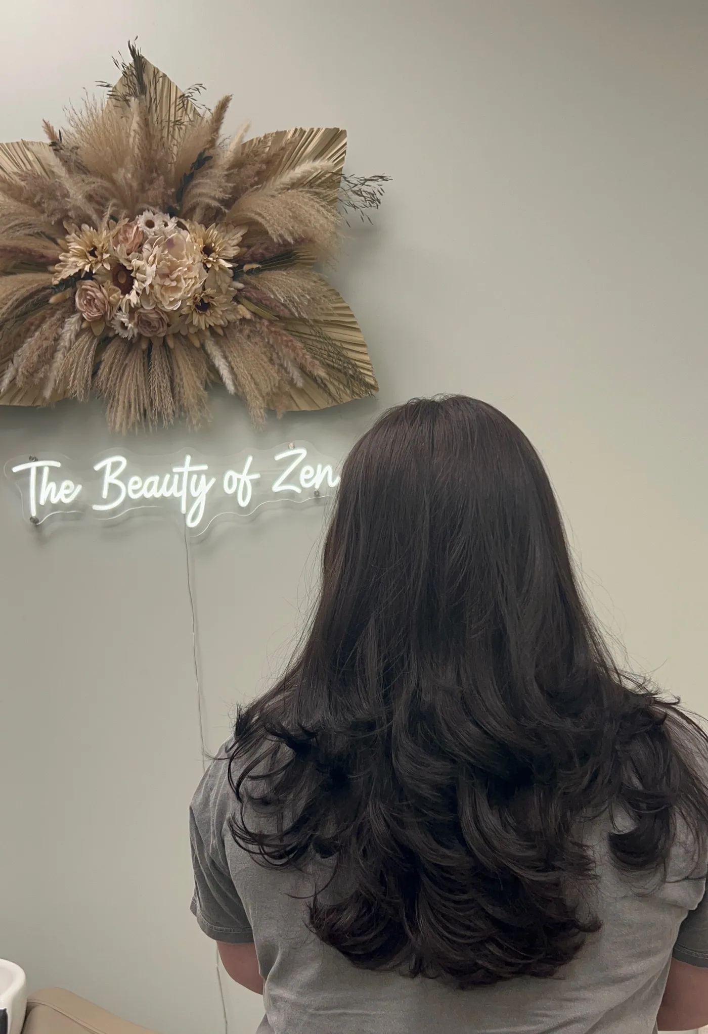 Long brunette layered cut with soft curtain styling at The Beauty of Zen, Worcester MA